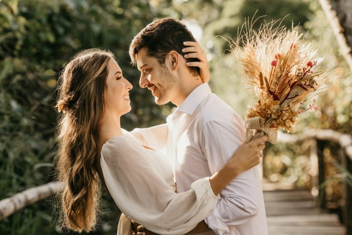 Photo by Jonathan Borba man in white dress shirt holding brown flower bouquet